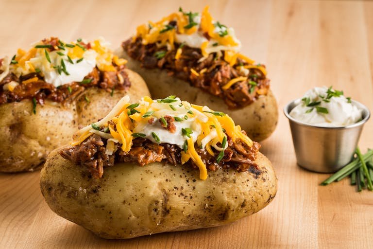Mouthwatering loaded baked potatoes topped with BBQ beef, cheese, and sour cream. Healthy Potato recipes