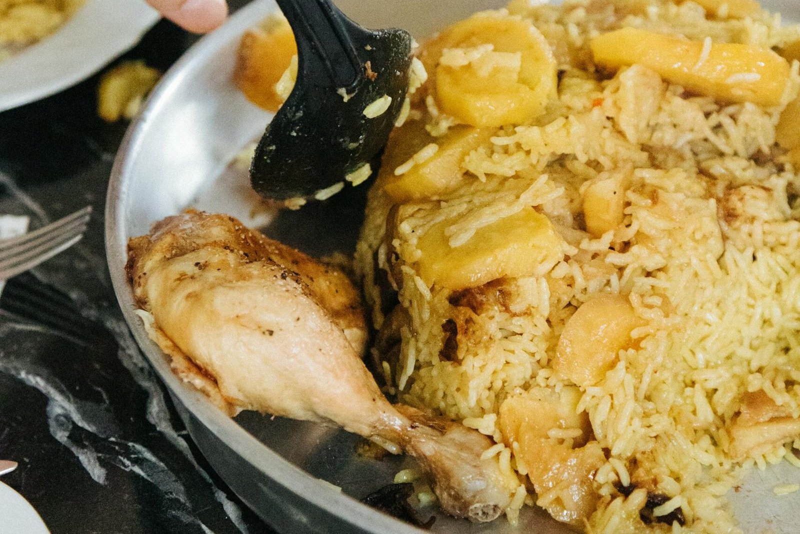 Potatoes in biryani? Close-up of a traditional biryani dish served in a wok